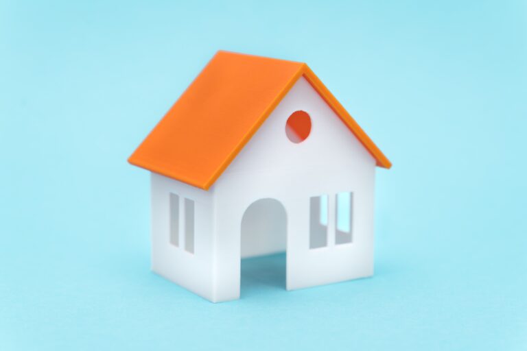White house with orange roof on blue background