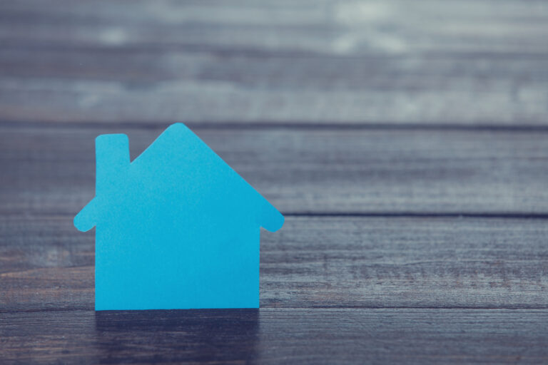 blue house on wooden background signalling estate agents and marketing tools at their disposal