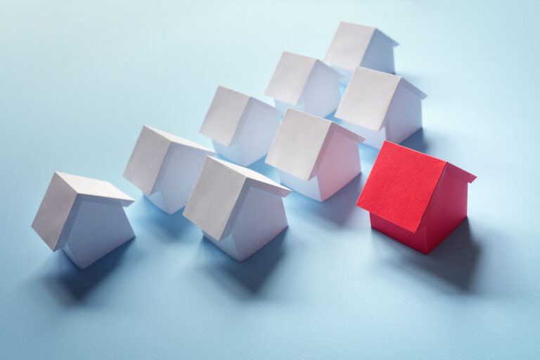 blue background with white monopoly houses and 1 red representing the hidden cost of copy-paste marketing