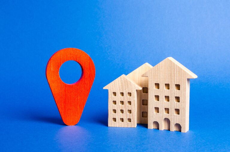 Houses and red navigation pointer pin signalling viewing enquiries